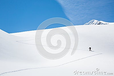 Skinning up the Asulkan Glacier in Glacier National Park, British Columbia. A man hikes on skis to access the Seven Steps to Stock Photo