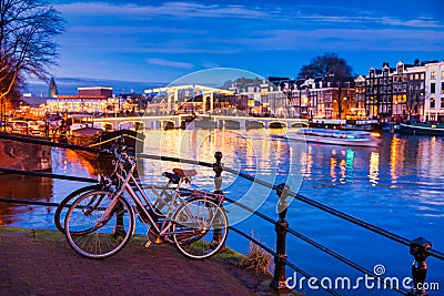 Skinny bridge and Amstel river in Amsterdam Netherlands at Dusk Stock Photo