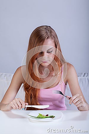 Skinny girl eats small breakfast Stock Photo