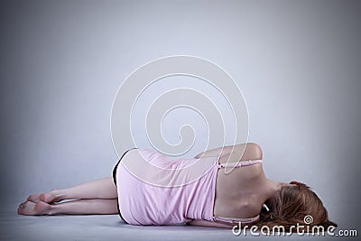 Skinny girl lying on the floor Stock Photo