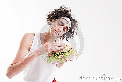 Skinny guy is seduced by unhealthy food Stock Photo