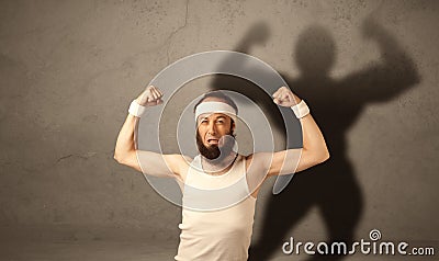 Skinny man with musculous shadow Stock Photo