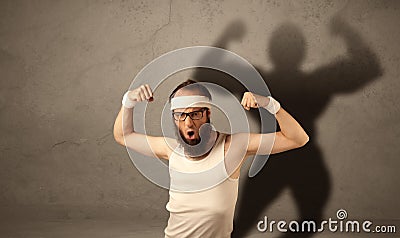 Skinny man with musculous shadow Stock Photo