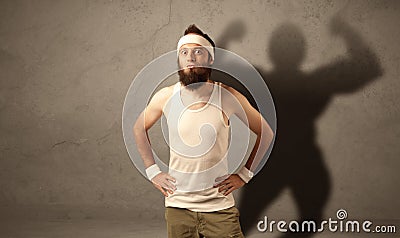 Skinny man with musculous shadow Stock Photo