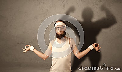 Skinny man with musculous shadow Stock Photo