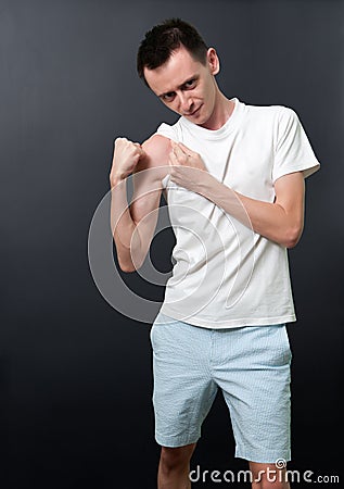 Skinny man showing his muscles Stock Photo