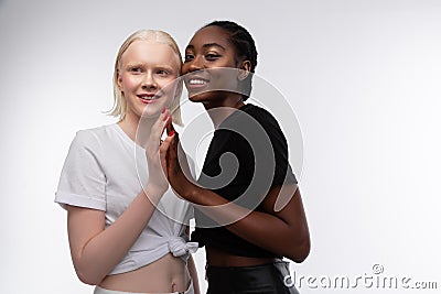 Skinny models with different skin color enjoying cooperation Stock Photo