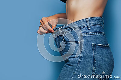 skinny woman body with Loose pants jeans, Light weight body with loose clothes, slender and Healthy body low fat concept Stock Photo