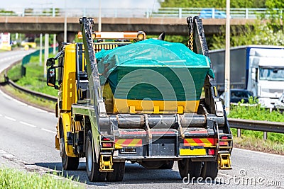 Skip lorry truck on uk motorway in fast motion Stock Photo