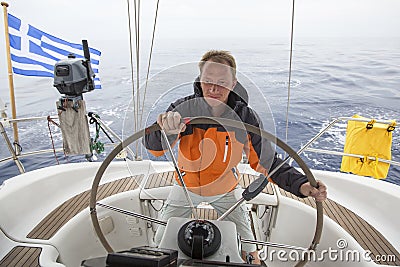 skipper drives the sailboat in the open sea. Yachting. Sailing. Stock Photo