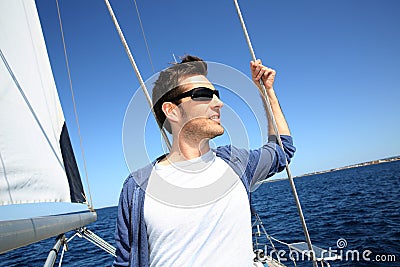 Skipper standing on sailing boat Stock Photo