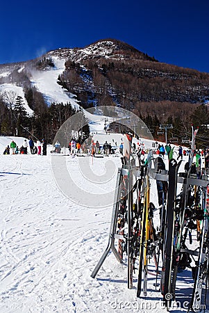 Skis rest on a rack at the bottom of a slope Editorial Stock Photo