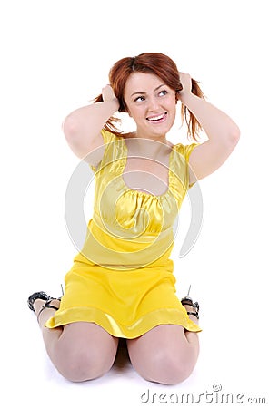 Skittish young woman's plays with her red hair Stock Photo