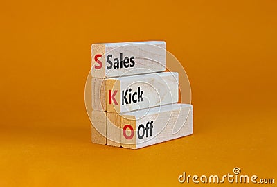SKO sails kick off symbol. Concept words SKO sails kick off on wooden blocks. Beautiful orange table, orange background, copy Stock Photo