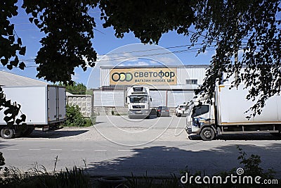 Truck and signage of Svetofor discounter grocery store with blue sky in background. Sunny daylight view. Editorial Stock Photo