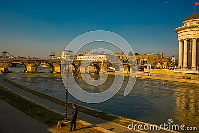 SKOPJE, NORTH MACEDONIA: View of the Vardar river and the Stone Bridge from the embankment in the center of Skopje. Editorial Stock Photo