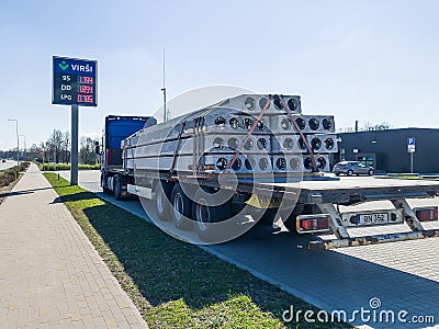 Skrunda, Latvia - April 22, 2022: A truck at a petrol station with concrete panels with holes Editorial Stock Photo