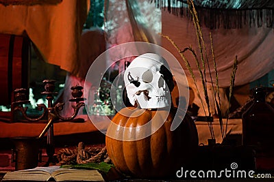 Skull with bug. Halloween party in living room with pumpkins, jack-o-lantern. Preparation Halloween holidays. Pumpkin Stock Photo