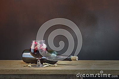 Skulls in the blood glass and wine on wooden table Stock Photo