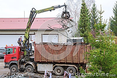 Skutec, Czech Republic, 21 November 2019: A grapple truck loads scrap industrial metal for recycling. Editorial Stock Photo