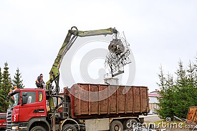 Skutec, Czech Republic, 21 November 2019: A grapple truck loads scrap industrial metal for recycling Editorial Stock Photo