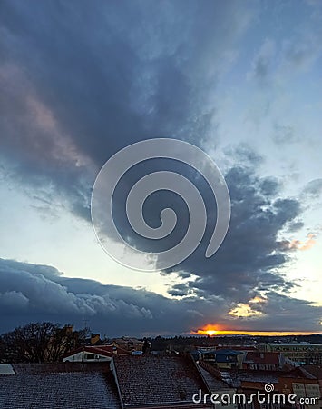 the sky above the roofs in the town, Serbia Editorial Stock Photo