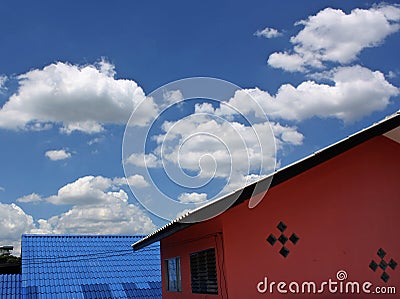 The sky and a cloud drift the top of house roof , Stock Photo