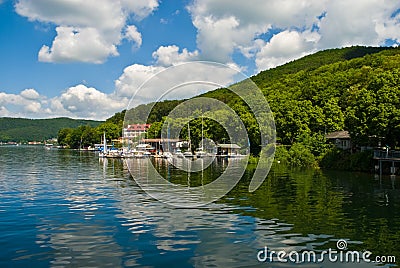 Sky and hills reflecting on sea in summer near near harbor Stock Photo