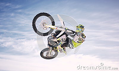 Sky, jump and man on off road motorbike for practice, training and extreme sports energy in nature. Professional dirt Stock Photo