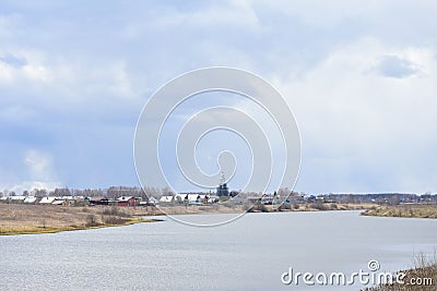 Sky, rainy storm clouds. Winding river Kostroma. Village on the banks of the river. The bell tower of the Church. Forest Stock Photo