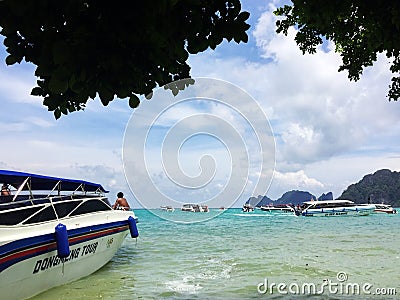 Sky,sea island,and boats,view under tree at the beach Editorial Stock Photo