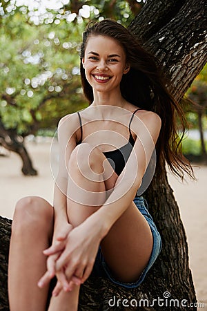 sky woman nature lifestyle paradise sea smiling relax tree vacation sitting Stock Photo
