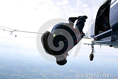 Skydiver tumbles out of an airplane Stock Photo