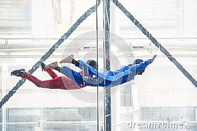 Skydivers in indoor wind tunnel, free fall simulator Stock Photo