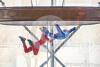 Skydivers in indoor wind tunnel, free fall simulator Stock Photo