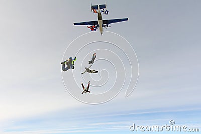 Formation skydiving. Skydivers are jumping out of an airplane into the sky. Editorial Stock Photo