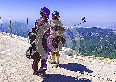 Skydivers on the observation deck put on equipment. they are wearing large briefcases with a parachute. active recreation, extreme Editorial Stock Photo