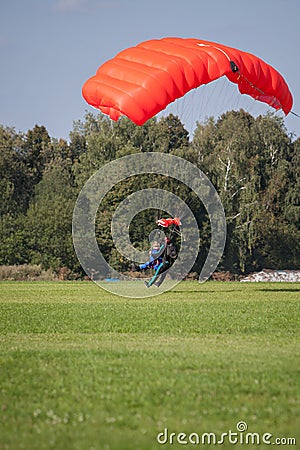 Skydivers parachutist on blue sky on sunset Stock Photo