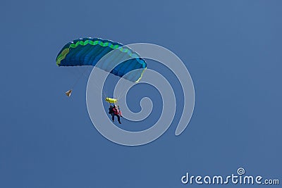 Skydivers parachutist on blue sky on sunset Stock Photo