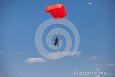 Skydivers parachutist on blue sky on sunset Stock Photo