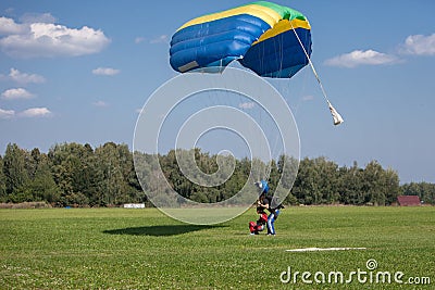 Skydivers parachutist on blue sky on sunset Editorial Stock Photo