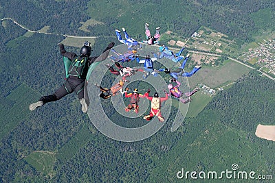 Skydiving. A cameraman makes photo and video about free falling skydivers. Stock Photo