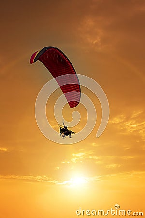 Skydiving sunset landscape of parachutist flying in soft focus. Para-motor flying silhouette with sun set. Silhouette of paraglide Stock Photo