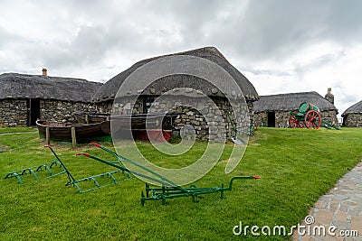 The Skye Museum of Island Life in Kilmuir on the coast of the Isle of Skye with thatched crofter cottages and boats Editorial Stock Photo