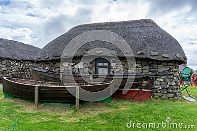 The Skye Museum of Island Life in Kilmuir on the coast of the Isle of Skye with thatched crofter cottages and boats Editorial Stock Photo