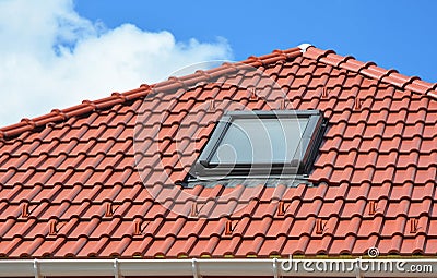 Skylight on red ceramic roof tiles house roof. Modern Roof Skylight. Attic Skylights Home Design. Roofing Construction. Stock Photo