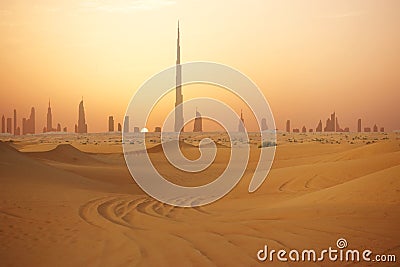 Skyline of Dubai at sunset or dusk, view from Arabian Desert Stock Photo