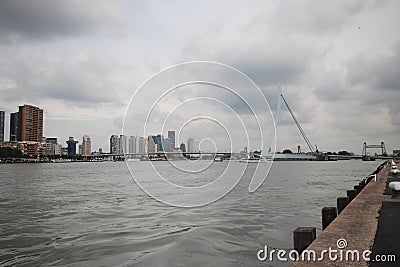skyline of river Nieuwe maas in the middle of Rotterdam with the Erasmusbrug bridge with nickname the Swan Editorial Stock Photo