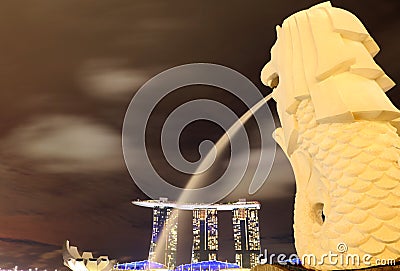 Skyline of Singapore by night, with Merlion statue and Marina Bay Sands Hotel and Singapore River Editorial Stock Photo
