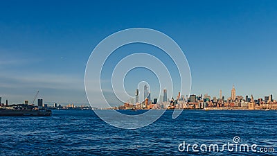 Skyline of uptown Manhattan over Hudson River under blue sky, at Stock Photo